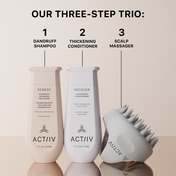 Three hair care products remedy dandruff shampoo, thickening conditioner, and scalp massager on a beige background.