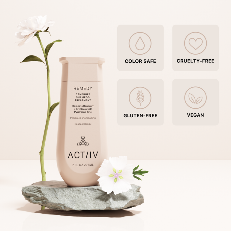 ACTIIV remedy dandruff shampoo bottle with flowers and product feature icons on a light background