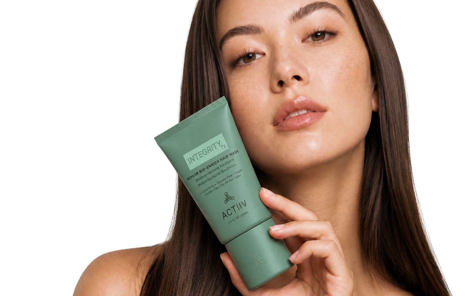 Woman with smooth brunette hair holding ACTIIV IntegrityRx Bio-Enrich Hair Mask for deep conditioning and damaged hair care