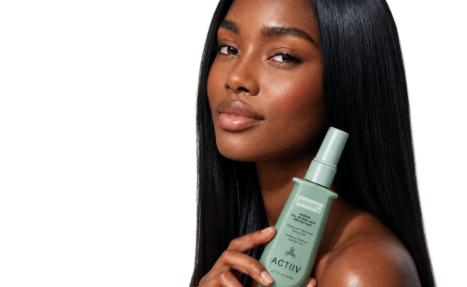 Model with sleek, glossy straight hair holding ACTIIV INTEGRITYrx Repair All-in-One Heat Protectant for heat protection, smoothing and styling prep.