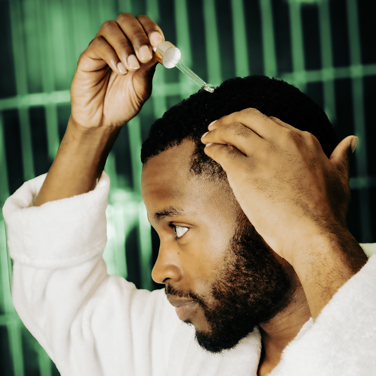 male applying the actiiv oil based thickening hair serum
