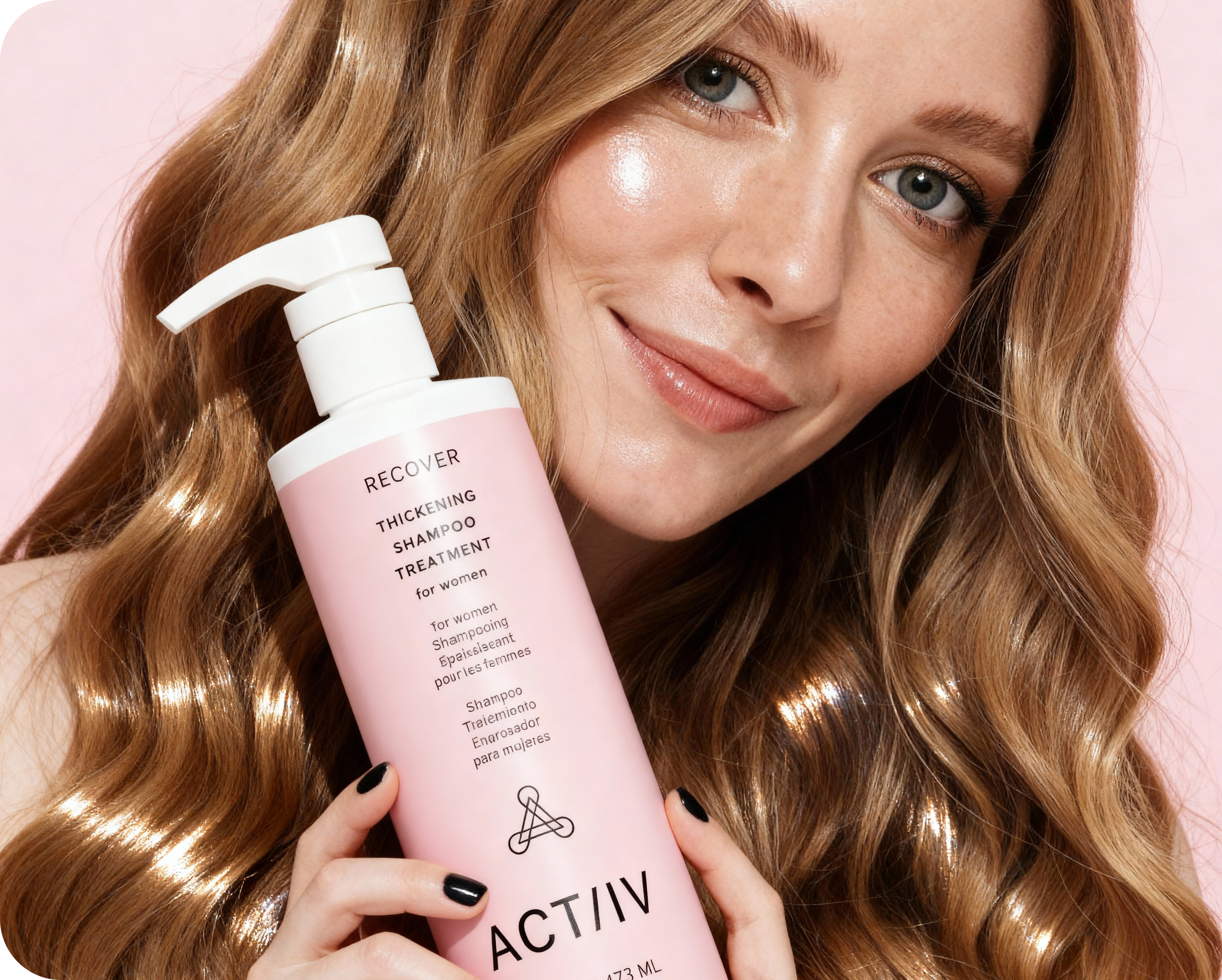 Woman holding a pink shampoo bottle with ACTIIV branding against a pink background