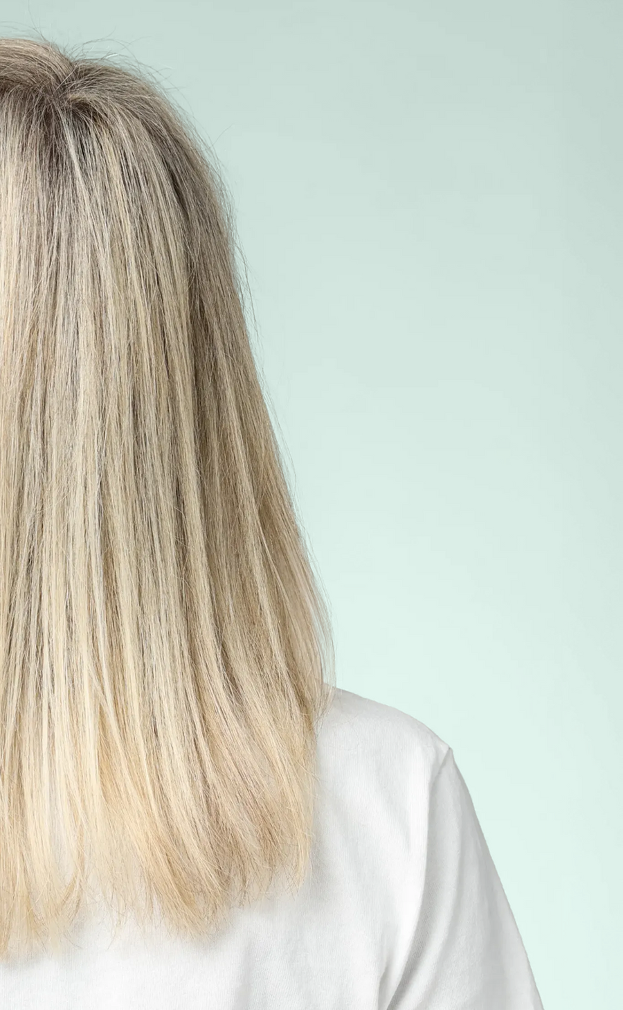 Back view of smooth, straight blonde hair with a soft, polished finish after using ACTIIV INTEGRITYrx hair care.