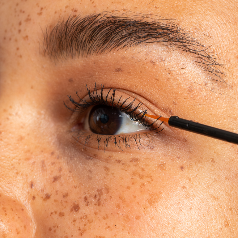Female applying Actiiv Amplify Lash and Brow Enhancing serum to eyelashes